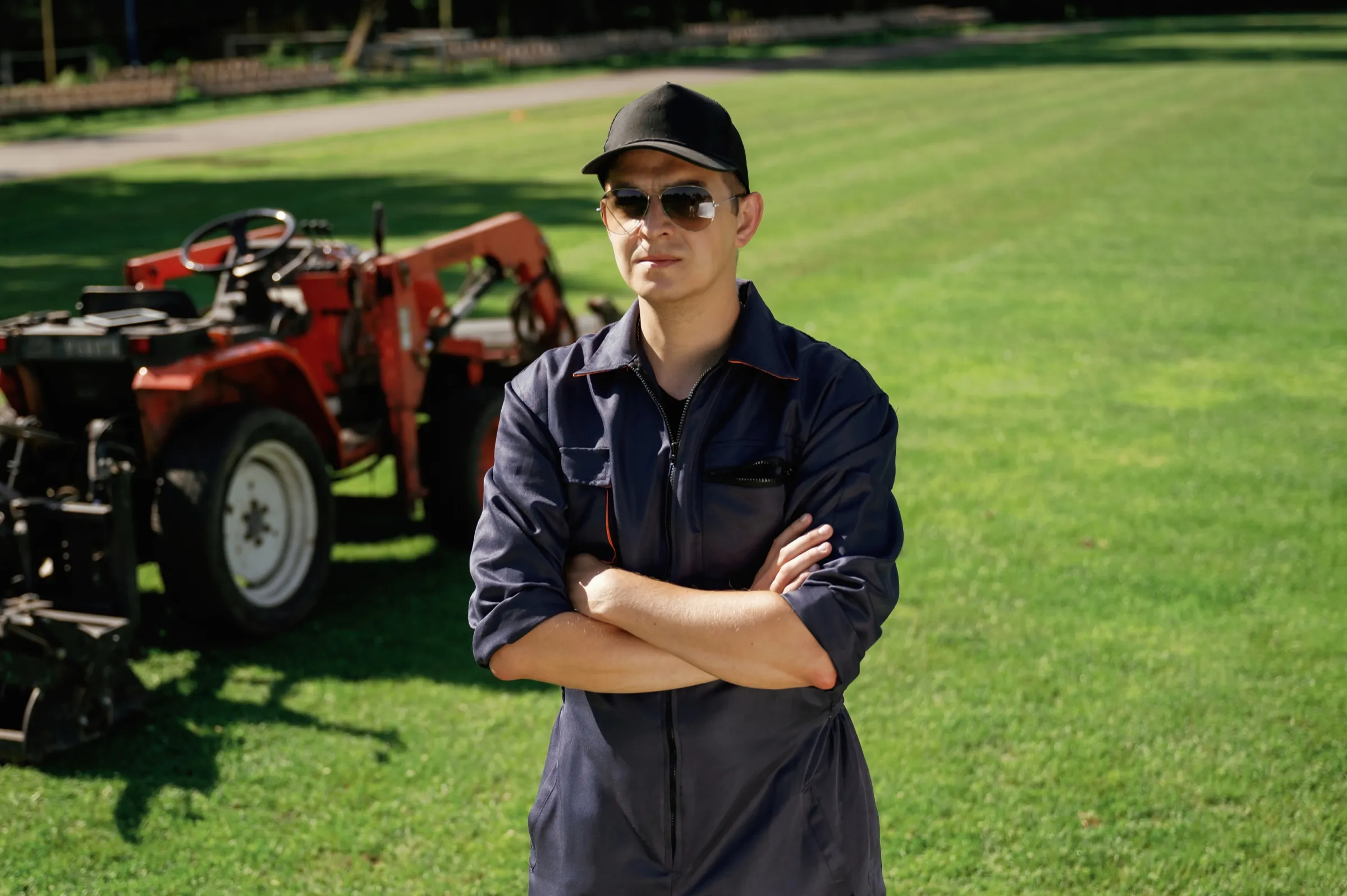 The owner of Your Lawn Co. standing on a freshly mowed lawn